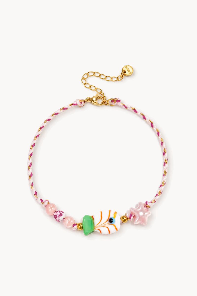 Ankle bracelet adorned with beads, stars, and a fish.