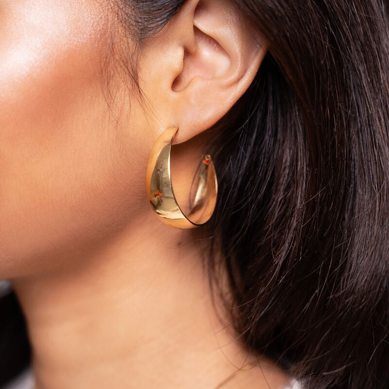 Large hoop earrings in a 90s style