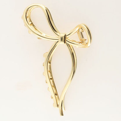 Pince à cheveux avec nœud couleur dorée