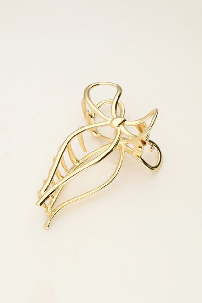 Pince à cheveux avec nœud couleur dorée