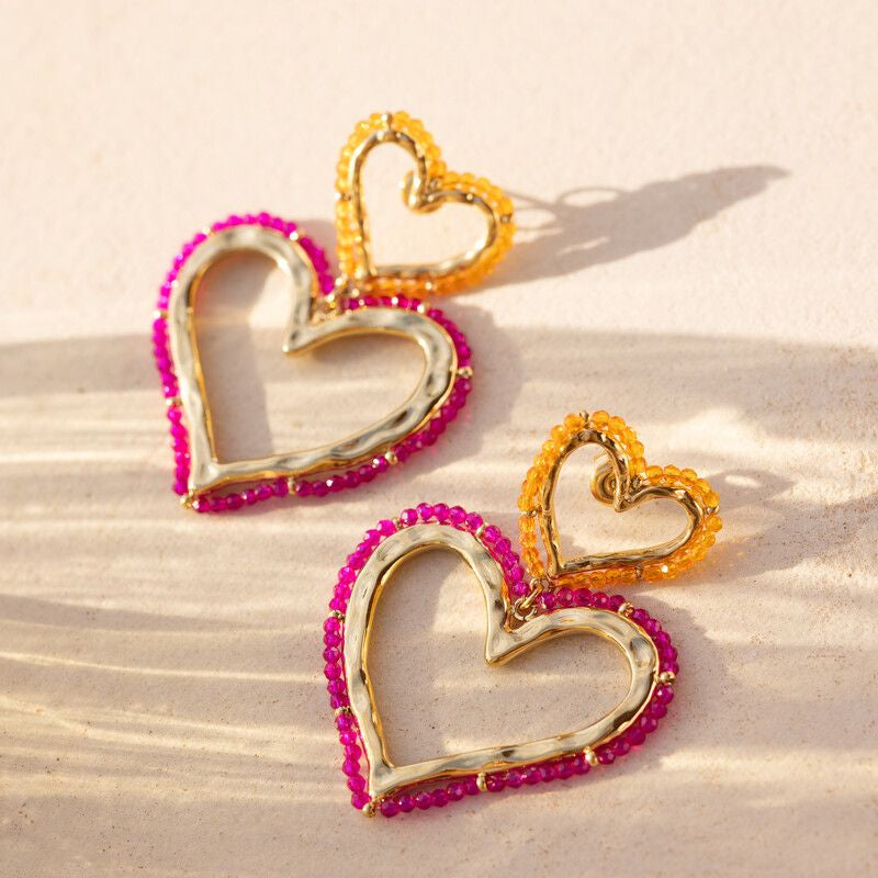 Boucles d'oreilles Sunrocks avec deux cœurs et des perles de verre